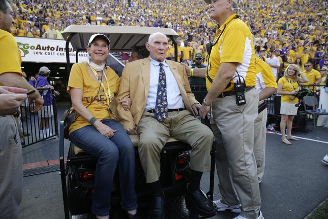 NFL great and LSU alumnus Y.A. Tittle, center, arrives in Tiger Stadium in the first half of a game between LSU and Mississippi State on Sept. 20, 2014, in Baton Rouge, La. [AP Photo / Gerald Herbert]