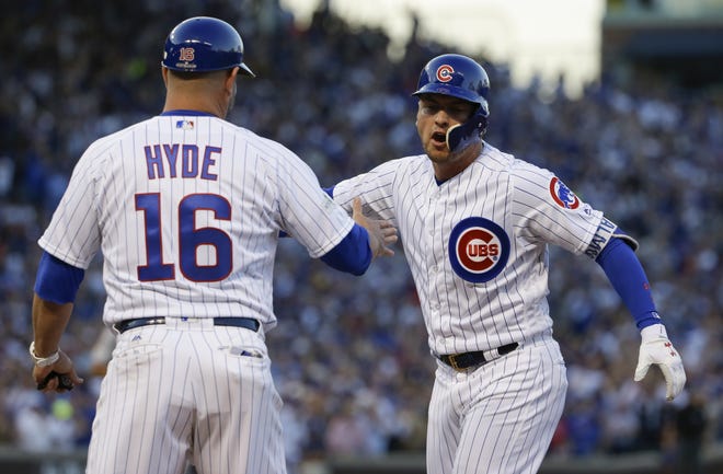 Chicago Cubs' Albert Almora Jr. is congratulated by first base coach Brandon Hyde after hitting an RBI single during the seventh inning of Game 3 of the National League Division Series against the Washington Nationals on Monday in Chicago. [AP Photo / Nam Y. Huh]