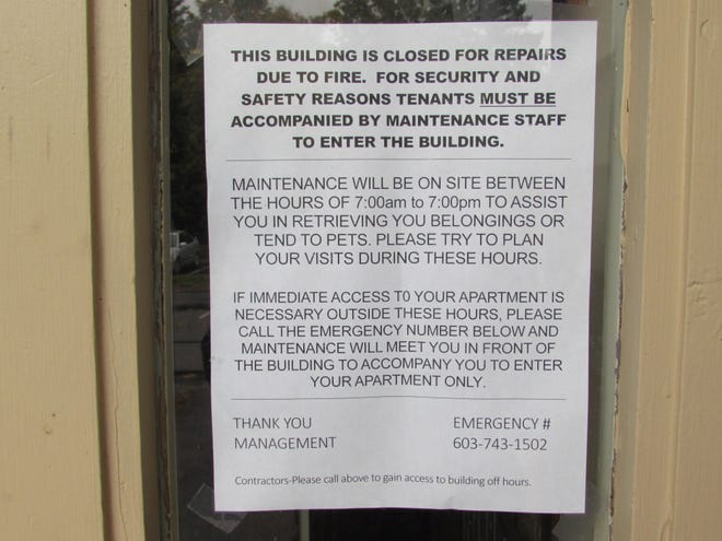 A Rutland Manor building, where a fire in the boiler room displaced residents on Friday, has not been cleared for occupancy. This sign posted on the door of the building off Rutland Street in Dover states that residents can only enter their apartment accompanied by maintenance staff. [Brian Early/Fosters.com]
