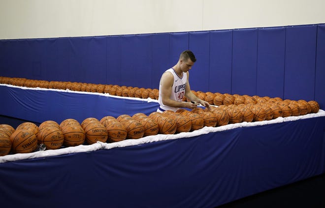 Los Angeles Clippers' Marshall Plumlee signs basketballs during an NBA media day Sept. 25 in Los Angeles. (AP Photo/Jae C. Hong)