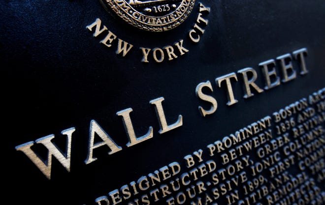 FILE - This Jan. 4, 2010, file photo shows an historic marker on Wall Street in New York. U.S. stocks are mixed early Monday, Oct. 9, 2017, as technology companies rise ahead of another round of company earnings later in the week. (AP Photo/Mark Lennihan, File)