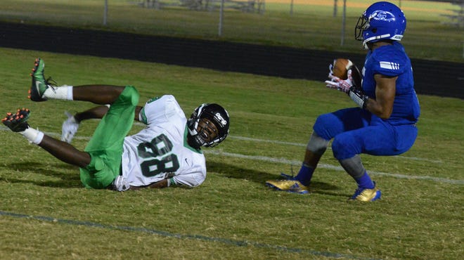 North Lenoir's Quwuan Barnes (88) watches as Greene Central's Taboris Bynum scores a touchdown in the first quarter Friday at Greene Central High School. [Janet S. Carter / The Free Press]