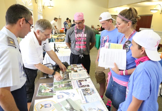 Civil Air Patrol Arkansas Wing Director of Communications Maj. William Leeper, from left, and Bradley Kidder, talk with the Kovitch family, Ken, Kaleb, 15, Melissa and Josh, 13, on Saturday, Oct. 7, 2017, about the volunteer opportunities with the Civil Air Patrol during the sixth annual Fort Smith Volunteer Fair at the Riverpark events center. [JAMIE MITCHELL/TIMES RECORD]