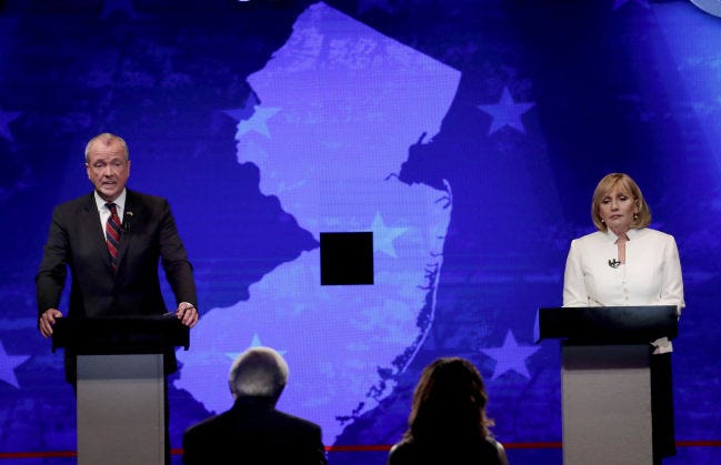Republican nominee Lt. Gov. Kim Guadagno (right) and Democratic nominee Phil Murphy answer questions during a gubernatorial debate against at the New Jersey Performing Arts Center on Tuesday, Oct. 10, 2017, in Newark, N.J.