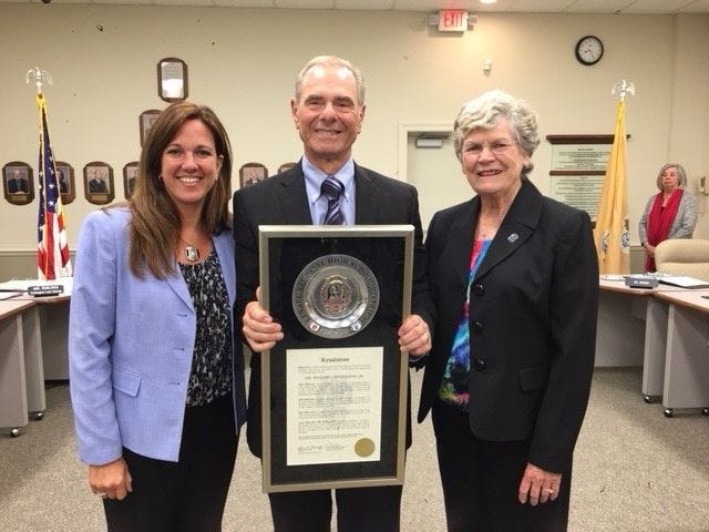 William Bisignano Jr., of Medford, (center) retired after 20 years of service to the Lenape Regional High School Board of Education. He was presented with a plaque at the September meeting by Superintendent Carol Birnbohm (left) and Board President Linda Eckenhoff (right). [COURTESY OF LENAPE REGIONAL HIGH SCHOOL DISTRICT]