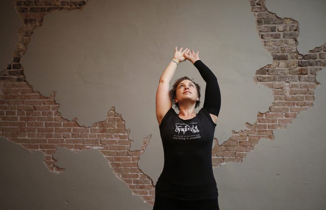 Brandie Sellers stretches prior to teaching a yoga class at Yoga Balance Studio in downtown McKinney, Texas, on Sept. 24. [Anja Schlein/TNS]