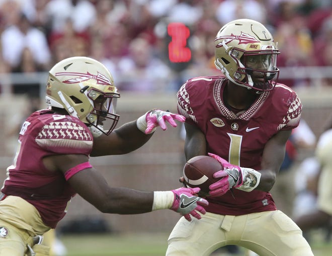 Florida State's James Blackman hands off to Cam Akers in the third quarter of a game against Miami on Saturday in Tallahassee. [AP Photo / Steve Cannon]