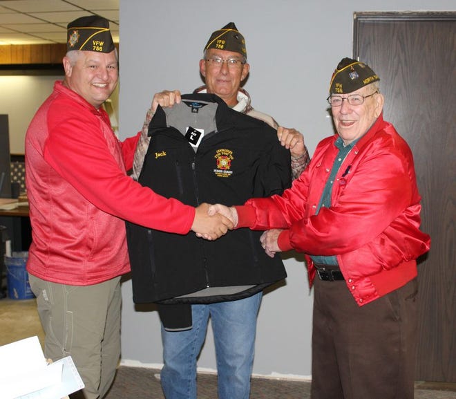 At Monday’s regular meeting at the VFW Wes Widmer congratulates Jack Nash for his years of service in the Honor Guard as Jack Volk holds up the jacket they had made for him.