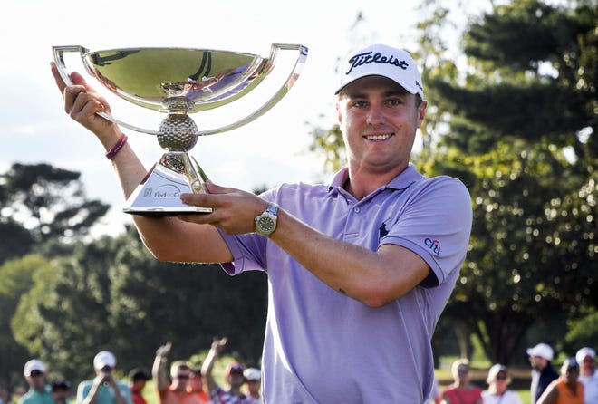 Justin Thomas holds the trophy after winning the Fedex Cup after the Tour Championship golf tournament at East Lake Golf Club in Atlanta. [AP Photo/John Amis]