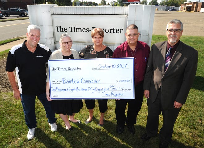 TIMES-REPORTER PAT BURK

Rainbow Connection executive director Carmel Haueter (center) receives a check for $10,858.97 representing the proceeds from the 40th annual Times-Reporter Charity All-Star Football Game held in July. Presenting the check are sports editor Roger Metzger, business office manager Mary Bodkins, local news editor Hank Keathley and publisher John Kridelbaugh.