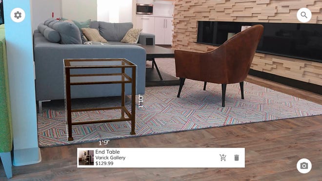 This May 2016 photo provided by Wayfair demonstrates the company’s augmented reality app, WayfairView, which allows shoppers to visualize furniture and decor in their homes at full-scale before they make a purchase. This image shows a screen grab taken with the app of an end table that has been selected to visualize in the space. (Wayfair via AP, File)
