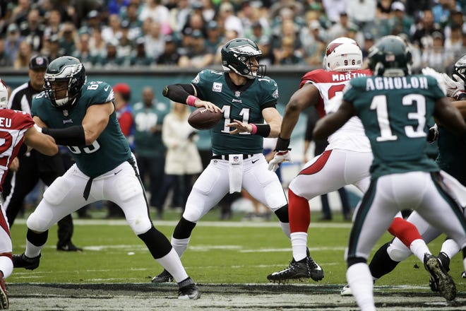 Eagles right tackle Lane Johnson (65) protects quarterback Carson Wentz (11) during Sunday's 34-7 victory over the Cardinals. [AP Photo/Matt Rourke]