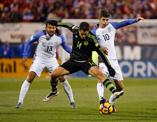 Mexico forward Javier Hernandez (14) splits between USA midfielder Christian Pulisic (10) and USA midfielder Jermaine Jones (13) during the second half of the World Cup qualifier soccer match at Mapfre Stadium on Nov. 11, 2016.