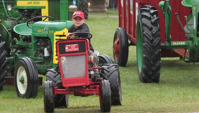 In this file photo, Lawson Rudisill drives his Cub Cadet 100 around the grounds at a previous Cotton Ginning Days festival. This year's festival will be held Oct. 13-15 at Dallas Park. [Mike Hensdill/The Gaston Gazette]