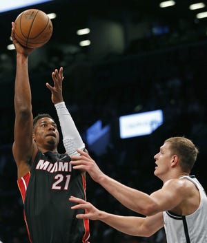 Miami Heat center Hassan Whiteside (21) shoots over Brooklyn Nets center Timofey Mozgov during the first half of a preseason NBA basketball game, Thursday, Oct. 5, 2017, in New York. (AP Photo/Kathy Willens)