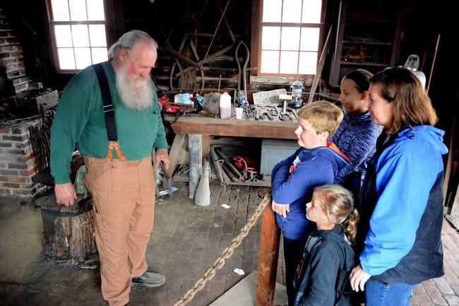 Blacksmith Rick Young, a member of the Medford Historical Society, offered a demonstration during the 2016 Apple Festival at Kirby's Mill in Medford. This year's 39th festival is from 9 a.m. to 4 p.m. on Saturday. [ARCHIVE PHOTO]