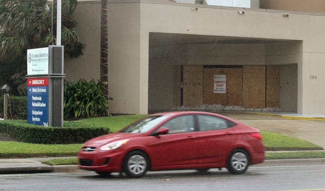 A car on State Road A1A rolls past the closed Florida Hospital Oceanside in Ormond Beach. The hospital has been shuttered since Hurricane Irma hit the area more than a month ago. [News-Journal/David Tucker]