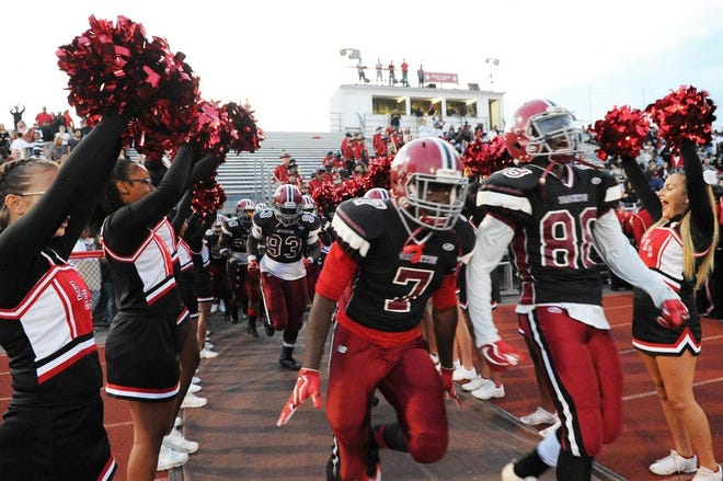 Brockton High School football team enters the field before their game on Friday, Sept. 15, 2017 at Marciano Stadium.