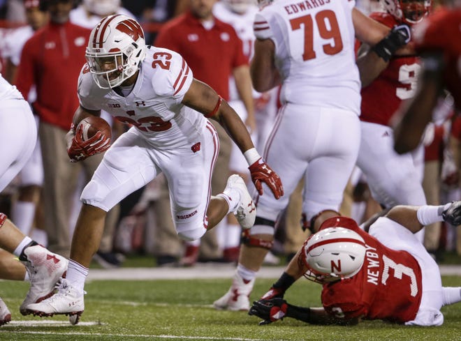 In this Oct. 7, 2017, photo, Wisconsin running back Jonathan Taylor (23) carries the ball past Nebraska linebacker Marcus Newby (3) during the second half in Lincoln, Neb. Taylor is fourth in the country in rushing at 153.4 yards per game, exhibiting balance, speed and tackle-breaking talent. [NATI HARNIK/THE ASSOCIATED PRESS]