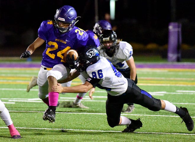 Upper Moreland's Caleb Mead dodges a tackle from Quakertown's Christian Morano. [CARL KOSOLA / STAFF PHOTOJOURNALIST]