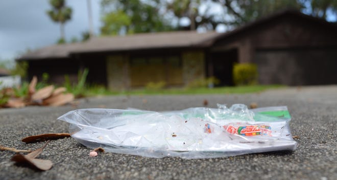 A flier advertising the Ku Klux Klan is ransacked by ants Monday, a day after many were discovered in driveways throughout the Sugar Forest neighborhood of Port Orange Sunday morning. Neighbors in the subdivision and the city's mayor found the message disturbing. [News-Journal/Casmira Harrison]