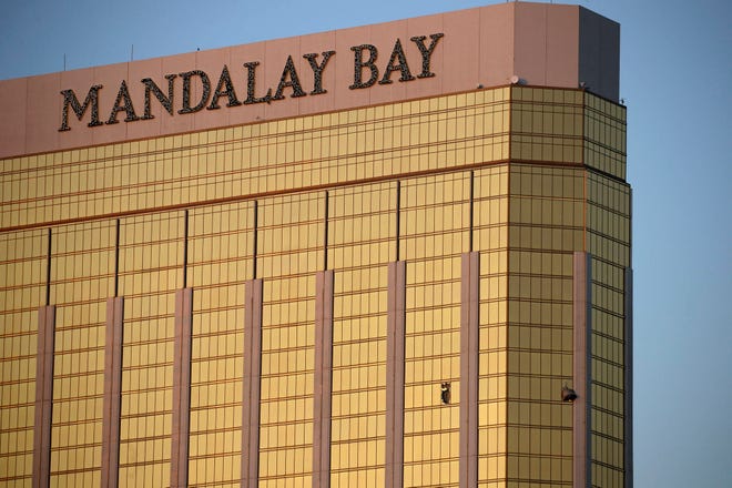 In this Monday, Oct. 2, 2017 file photo, drapes billow out of broken windows at the Mandalay Bay resort and casino on the Las Vegas Strip, following a deadly shooting at a music festival in Las Vegas. (AP Photo/John Locher, File)