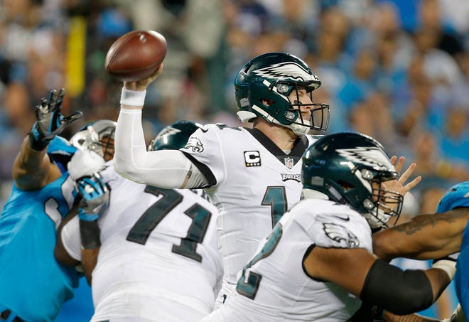 The Philadelphia Eagles’ Carson Wentz (11) looks to pass against the Carolina Panthers in the second half of a game in Charlotte, N.C., on Thursday, Oct. 12, 2017. (AP Photo/Bob Leverone)