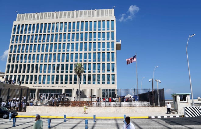 FILE - In this Aug. 14, 2015, file photo, a U.S. flag flies at the U.S. embassy in Havana, Cuba. The Associated Press has obtained a recording of what some U.S. Embassy workers heard in Havana, part of the series of unnerving incidents later deemed to be deliberate attacks.  (AP Photo/Desmond Boylan, File)