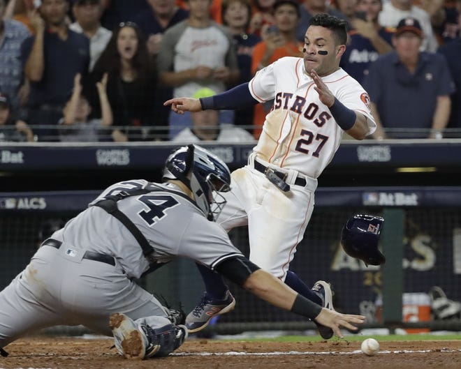 Houston's Jose Altuve scores the game-winning run past New York Yankees Gary Sanchez during the ninth inning of Game 2 of the ALCS Saturday in Houston. [AP photo]