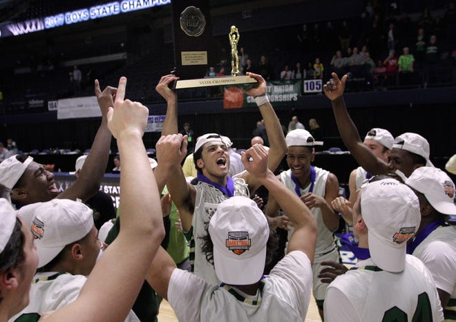 Justin Mazzulla hoists his team's trophy after Hendricken defeated Shea for the state basketball title in March at URI's Ryan Center. Mazzulla is now a freshman on the George Washington University team.