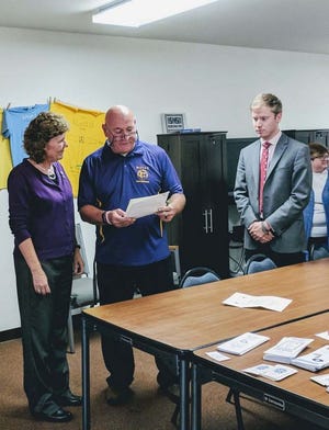Pictured from the left are Phyllis Todd, Executive Director of the Fulton-Mason Crisis Service, Mayor Kent McDowell (reading a proclamation designating October Domestic Violence Awareness Month), and Canton Alderman, Christopher Jump.