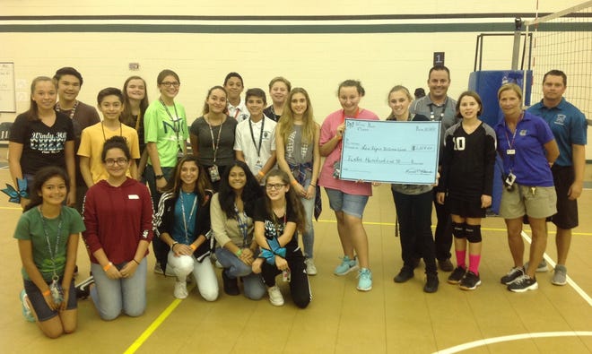 Windy Hill Middle School students and faculty with a check representing $1,200 they raised for the victims of the Las Vegas shootings. [SUBMITTED]