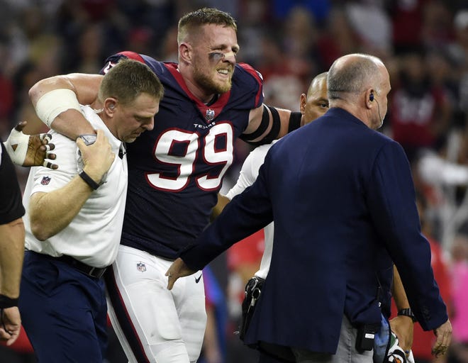 Houston Texans defensive end J.J. Watt (99) is helped off the field after an injury during the first half of a game against the Kansas City Chiefs on Oct. 7 in Houston. [AP Photo / Eric Christian Smith, File]