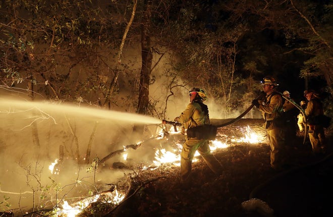 Fire crews battle a wildfire Saturday, Oct. 14, 2017, in Santa Rosa, Calif. (AP Photo/Marcio Jose Sanchez)