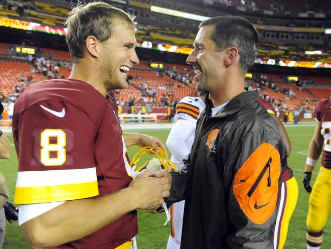 FILE - In this Aug. 18, 2014, file photo, Washington Redskins quarterback Kirk Cousins (8) talks with then-Cleveland Browns offensive coordinator Kyle Shanahan after an NFL preseason football game, in Landover, Md. Facing the first offensive coordinator who believed in him in now San Francisco 49ers coach Kyle Shanahan, Cousins is still evolving and improving as a quarterback for the Redskins. (AP Photo/Richard Lipski, File)