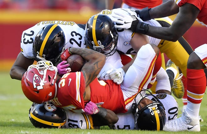 Kansas City Chiefs running back Charcandrick West is stopped by the Pittsburgh Steelers defense in the closing minutes of the first half Sunday at Arrowhead Stadium in Kansas City, Mo. [JOHN SLEEZER / KANSAS CITY STAR]