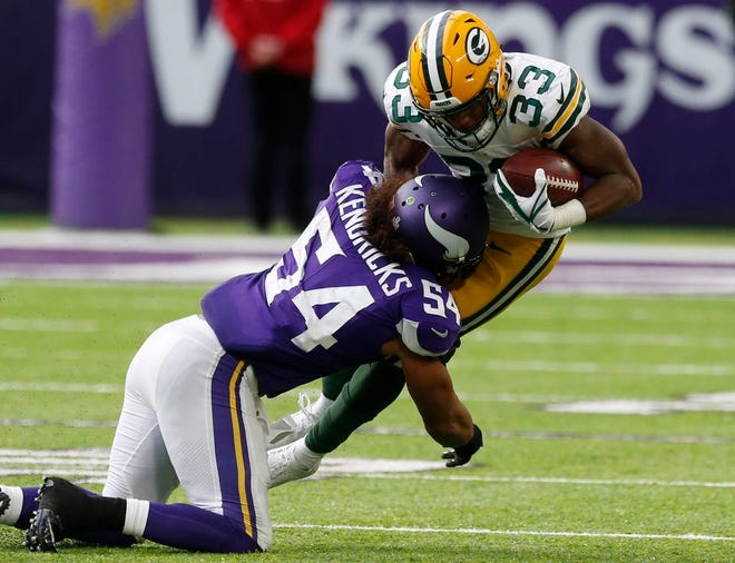 Minnesota Vikings middle linebacker Eric Kendricks (54) tackles Green Bay Packers running back Aaron Jones (33) in the second half of Sunday's game. [The Associated Press]