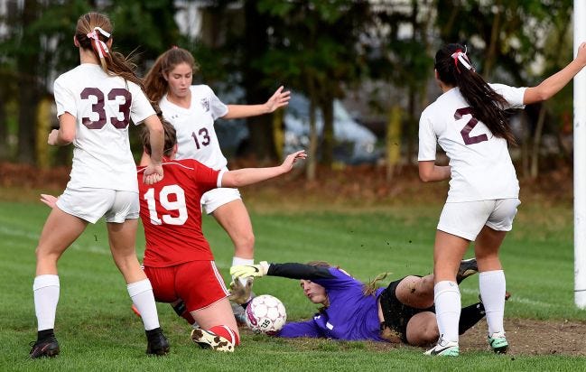 Holy Cross goalie Karli Byrne comes up with a save during a girls soccer game Monday, Oct. 16, 2017.