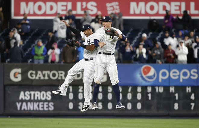 New York Yankees' Aaron Hicks and Aaron Judge celebrate after Game 3 of their American League Championship Series against the Houston Astros on Monday. [AP Photo/Kathy Willens]