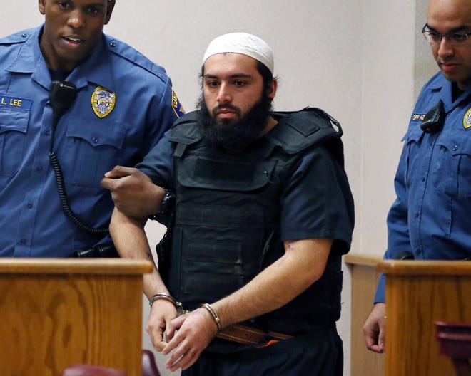 FILE - In this file photo from Tuesday, Dec. 20, 2016, Ahmad Khan Rahimi, the man accused of setting off bombs in New Jersey and New York in September is led into court in Elizabeth, N.J. On Monday, Oct. 16, 2017, Ahmad Khan Rahimi was convicted Monday of planting two pressure-cooker bombs on New York City streets, including one that injured 30 people with a rain of shrapnel. (AP Photo/Mel Evans, File)