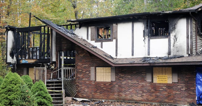 A state police fire marshal is investigating the cause of an early-morning fire that destroyed this Mohawk Trail home in Pocono Farms Country Club, Coolbaugh Township, on Monday, Oct. 16, 2017. No injuries were reported. [Keith R. Stevenson/Pocono Record]