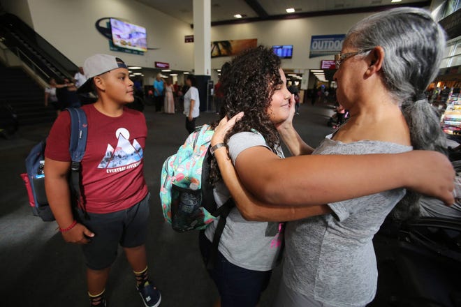 Ricardo Ramirez Buxeda/Orlando Sentinel/TNS Mizraim Ruiz Collazo, 14, looks on as his sister, Samiliz Ruiz Collazo, 10, hugs their grandmother, Beatriz Rodriguez, when they arrived at the Sanford airport from Puerto Rico on Oct. 13, 2017.