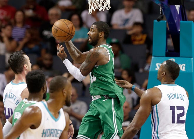 Kyrie Irving, center, and the new-look Celtics open the 2017-18 NBA season tonight at the Cavaliers, Irving's former team. [AP Photo/Chuck Burton]