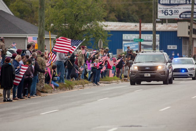 People line Ramsey Street outside Jernigan-Warren Funeral Home on Monday to show their respects as the remains of Staff Sgt. Bryan Black and Staff Sgt. Jeremiah W. Johnson are returned to Fayetteville. [photo/Raul F. Rubiera/The Fayetteville Observer]