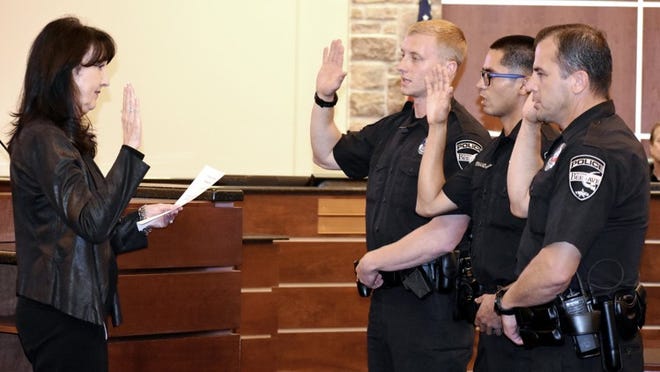 Bee Cave Mayor Caroline Murphy swears in new city patrol officers (from left) Matthew Stevko, Adrian Hernandez and Ray Duran during the Oct. 10 City Council meeting. LESLEE BASSMAN FOR LAKE TRAVIS VIEW