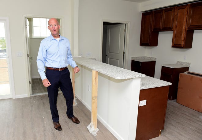 Developer Mitchell Davis shows off a kitchen area inside Jackie's Crossing, a new apartment complex on Maple Avenue. [CARL KOSOLA / STAFF PHOTOJOURNALIST]