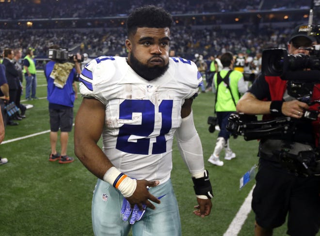 Dallas Cowboys' Ezekiel Elliott walks off the field after losing to the Green Bay Packers in an NFL divisional playoff football game on Jan. 15 in Arlington, Texas. Elliott will be allowed to play this week against the San Francisco 49ers, a court ruled Tuesday. [AP Photo / Michael Ainsworth, File]