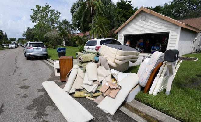 Flood-damaged furniture is put out for trash at a home in Centre Lake after an August 2017 storm. [Herald-Tribune staff photo / Dan Wagner]