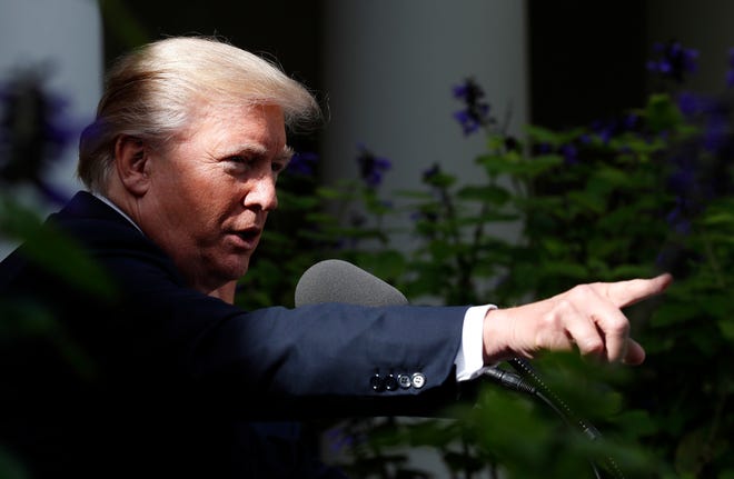 President Donald Trump points to a reporter to ask a question during a media availability in the Rose Garden with Senate Majority Leader Mitch McConnell of Ky., after their meeting at the White House, Monday, Oct. 16, 2017, in Washington. (AP Photo/Alex Brandon)