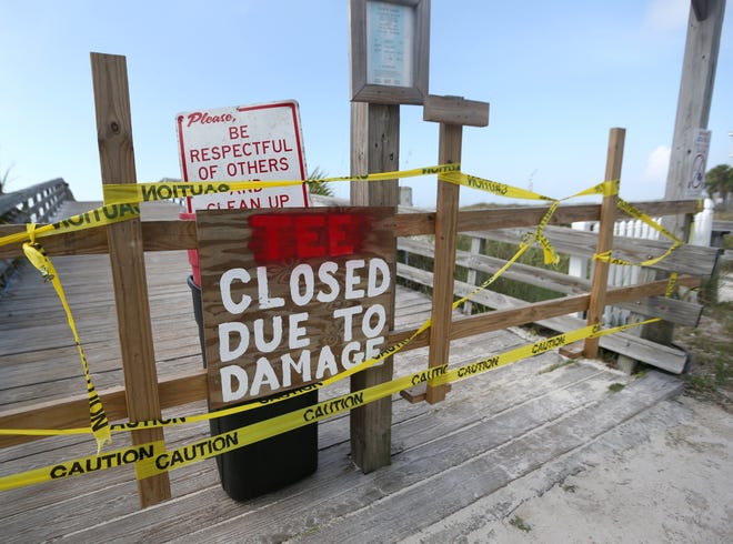 Caution tape and signs warn beach goers that the Mexico Beach City Pier is closed on Monday. Severe weather from Hurricane Nate damaged the "tee section" of the Mexico Beach City Pier. [PATTI BLAKE/THE NEWS HERALD]